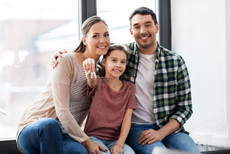 Happy family holding keys to their beloved home